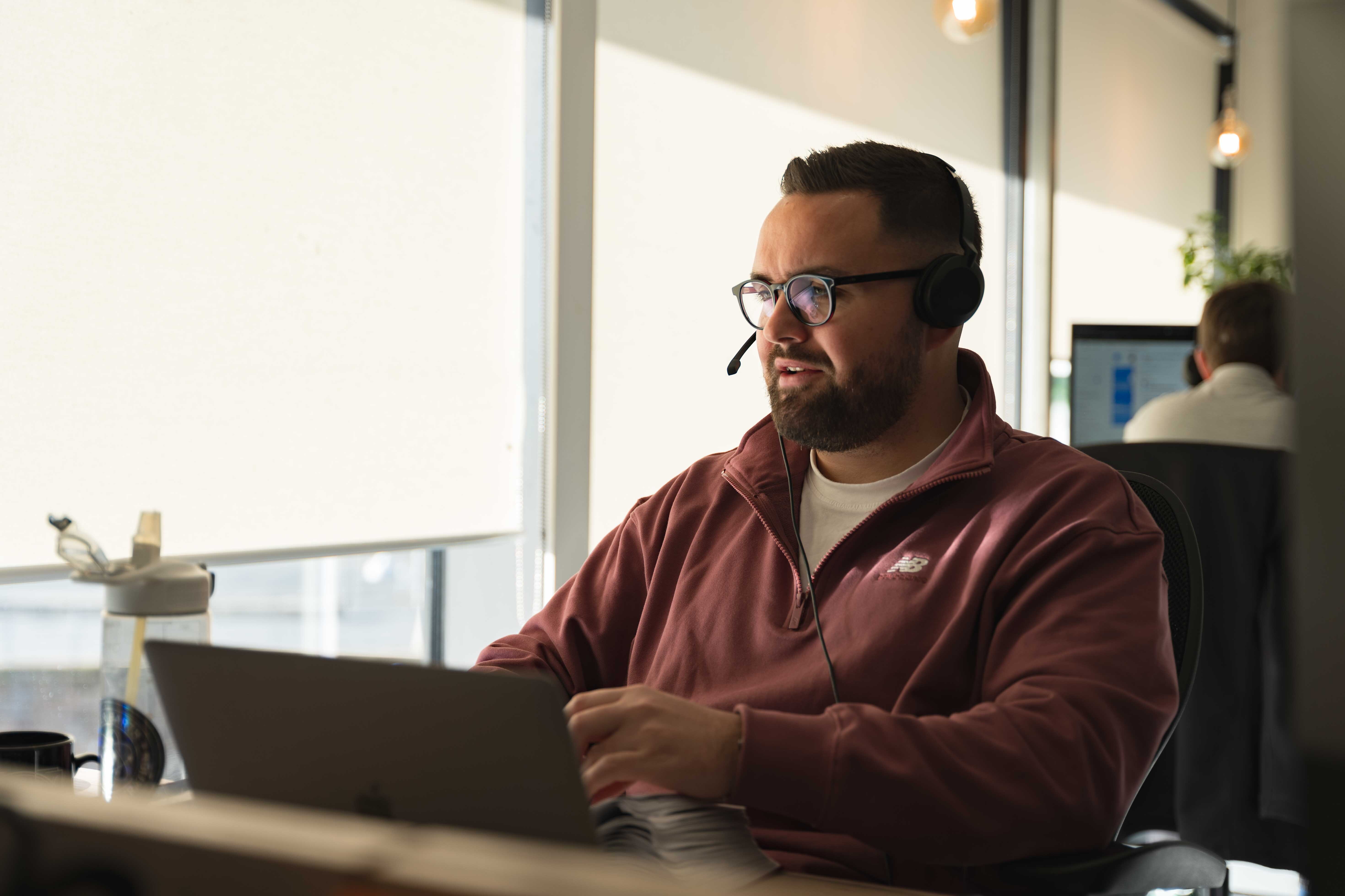 A customer service team member wearing a headset